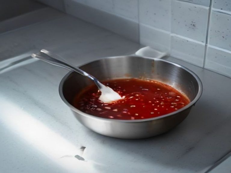A spoon rest and splatter screen keeping the stovetop area clean.