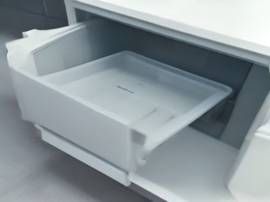 Clean freezer drawer pulled forward in a modern kitchen