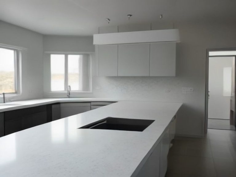 Spotless quartz counter area surrounding a sleek gooseneck faucet