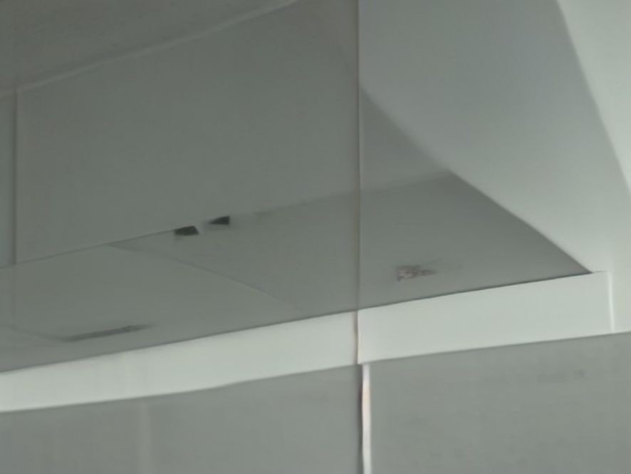 A sparkling stainless steel stove hood vent free of dust and grease.