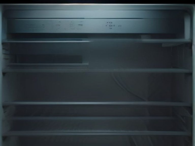 A macro view showing a contrast between dirty and clean refrigerator coils.