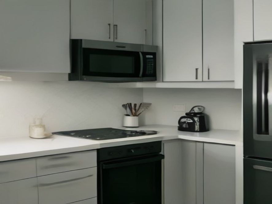 Kitchen countertop with major small appliances in a modern home setup.