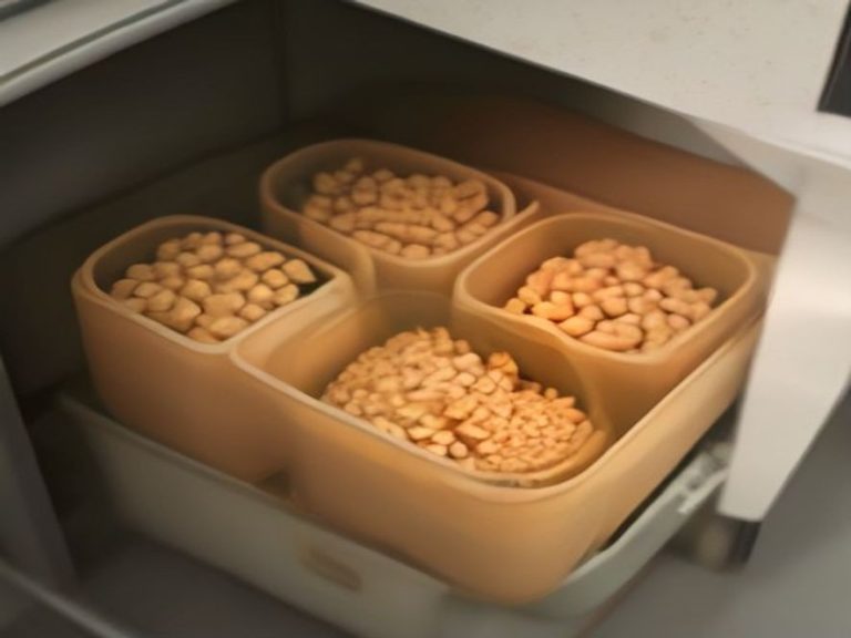 Stackable airtight bulk food containers in a compact cabinet.