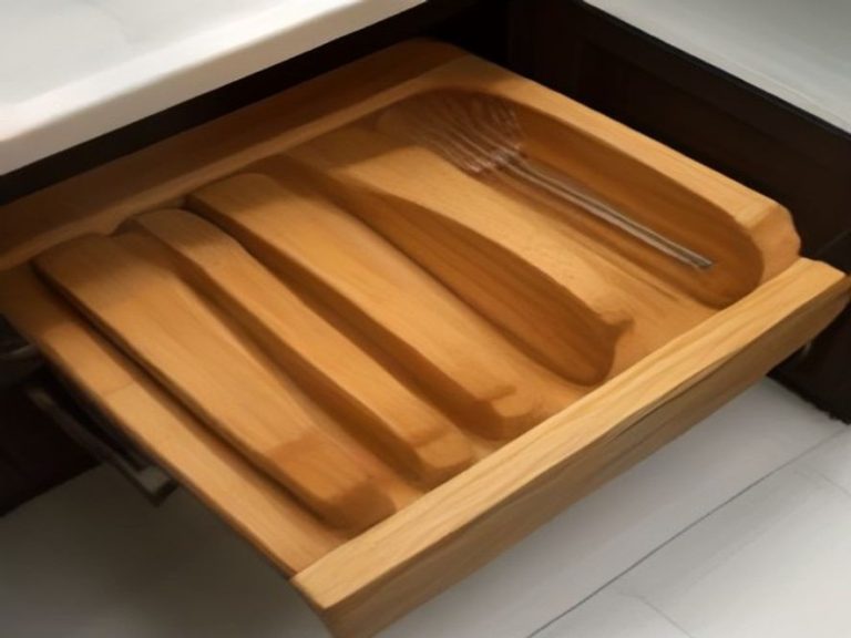 An organized shallow kitchen drawer with custom dividers for long utensils.