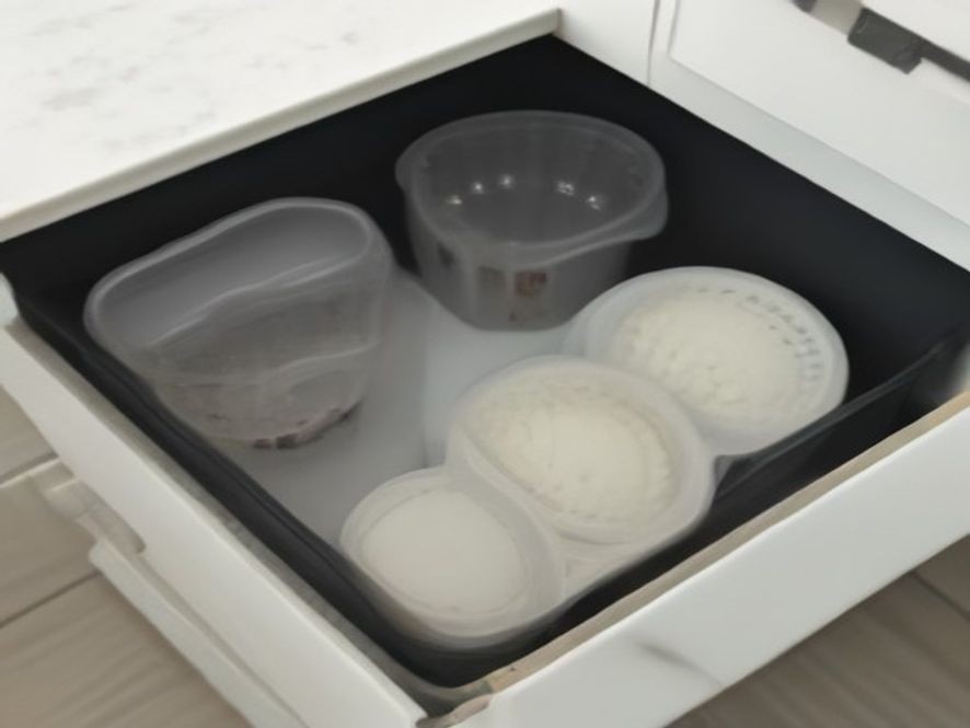 Collapsible and nestable tools stored neatly inside a kitchen drawer.