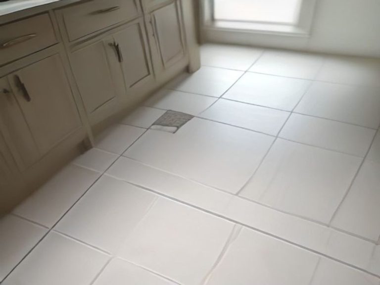 Restored light-colored tile grout lines on a kitchen floor