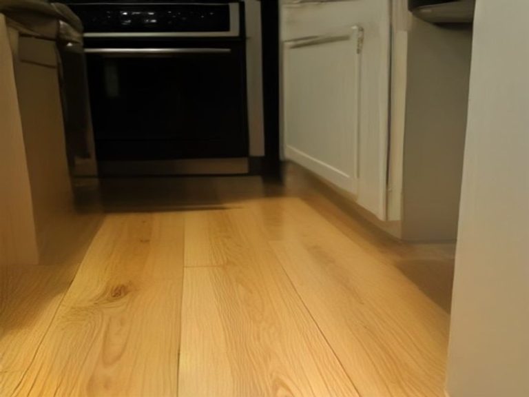 A clean floor area exposed and sanitized beneath a moved kitchen appliance.