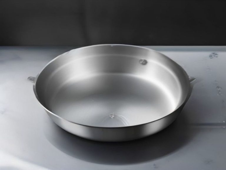 A spotless stainless steel skillet prepared on an induction stove.