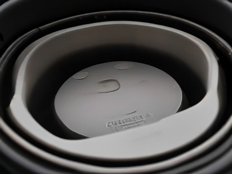 Close-up view of heating element wires inside an air fryer top chamber.