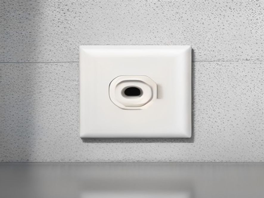 An air fryer heavy-duty power cord connected securely to a wall electrical socket.