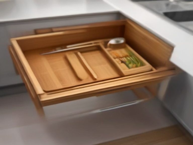 Custom-fitted bamboo drawer tray keeping utensils firmly in place